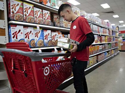 An employee stocks cereal in the grocery area of a Target Corp. store in Chicago, Illinois