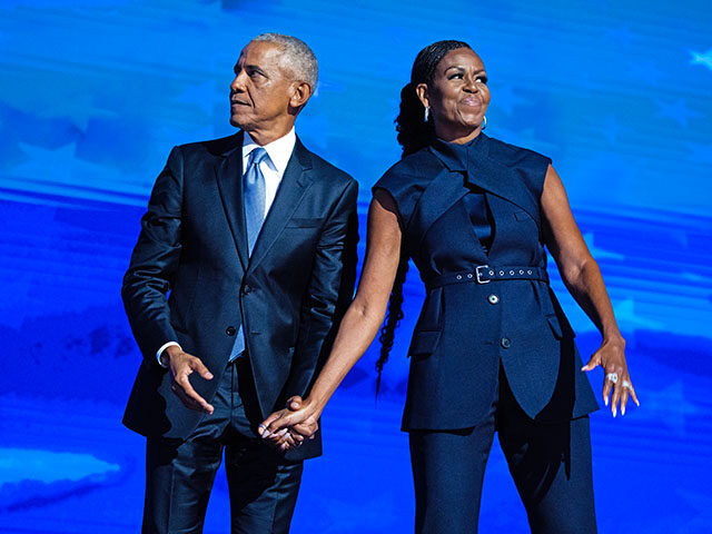 Former President Barack Obama and former first lady Michelle Obama appear on stage on the