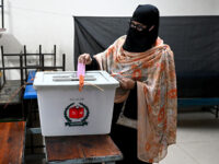 A female voter casts her ballot to vote during the 13th general election in Dhaka, Banglad
