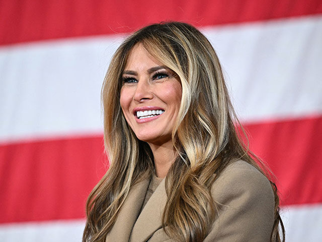 US First Lady Melania Trump smiles as US President Donald Trump (out of frame) speaks to m