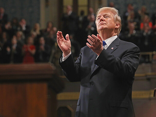 U.S. President Donald Trump applauds while delivering a State of the Union address to a jo