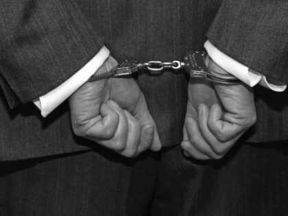 Handcuffed man in suit