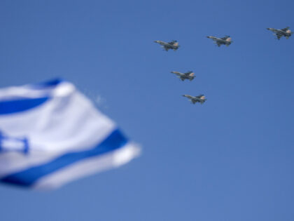 Israeli F-16 fighter jets perform during an air show over the beach in the coastal city of