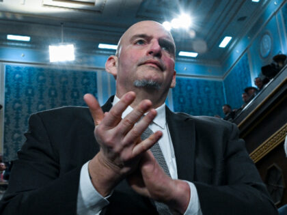 Senator John Fetterman (D-PA) and Senator Peter Welch (D-VT) applaud as U.S. President Don