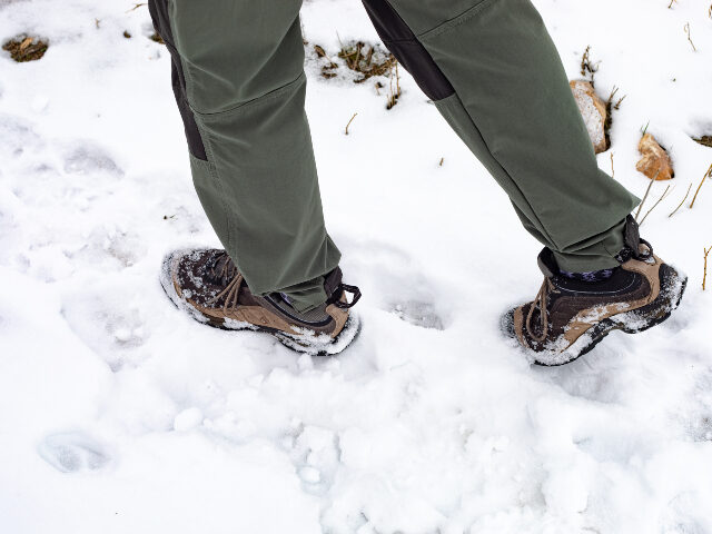Low view man walking in snow