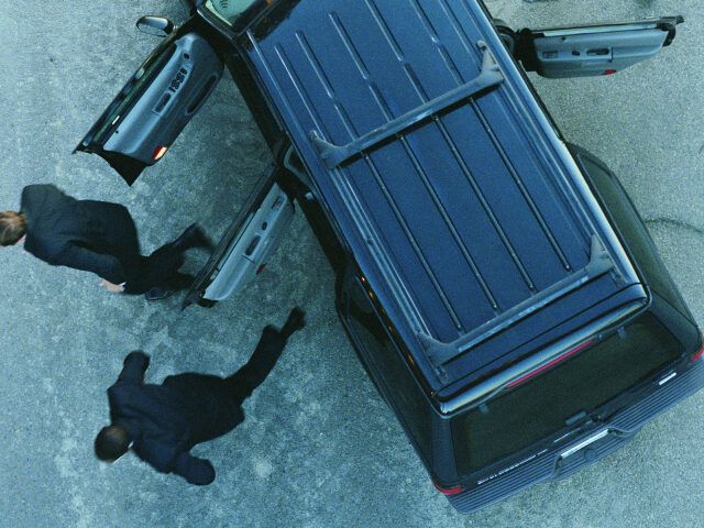 Men running out of car on highway