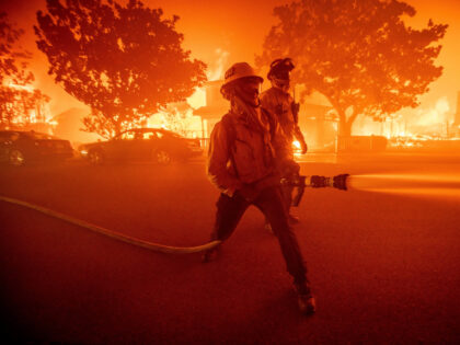 FILE - Firefighters battle the Palisades Fire as it burns multiple structures in the Pacif