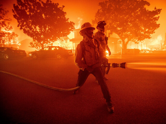 FILE - Firefighters battle the Palisades Fire as it burns multiple structures in the Pacif