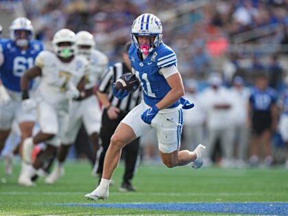 ORLANDO , FL - DECEMBER 27: BYU Cougars wide receiver Parker Kingston (11) runs ater a cat