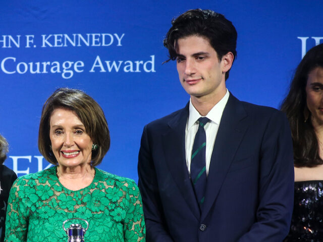 Speaker of the United States House of Representatives Nancy Pelosi, center, receives the P