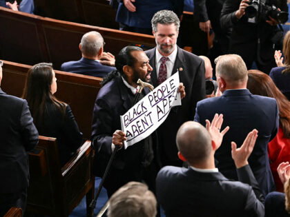 US Representative Al Green, Democratic from Texas, exits as he holds a sign reading "Black
