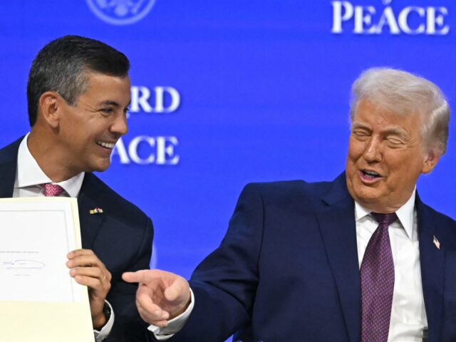 Santiago Peña and trump Paraguay's President Santiago Pena (L) holds a signed founding charter as US President Don