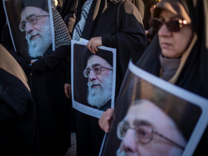 Supporters with Posters Ayatollah Khamenei Veiled women hold portraits of Iran's Supreme Leader, Ayatollah Ali Khamenei, while p