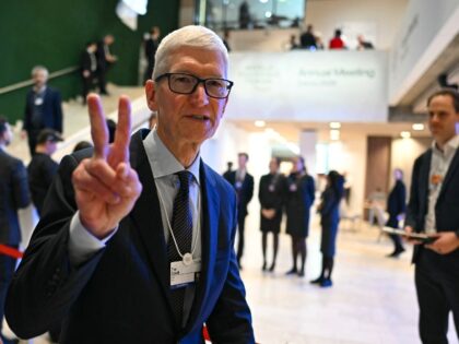 Tim Cook flashing Apple's Victory
