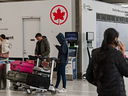 Travelers near the Air Canada check-in area at Toronto Pearson International Airport in Mi