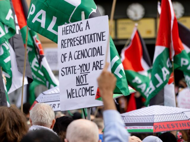 MELBOURNE, AUSTRALIA - FEBRUARY 09: A protester hold a homemade sign on February 09, 2026