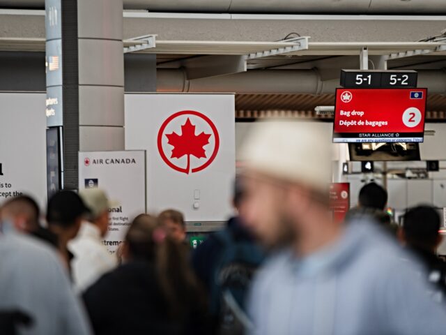 Travelers check in with Air Canada at Toronto Pearson International Airport in Mississauga