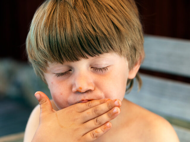 child licking his fingers