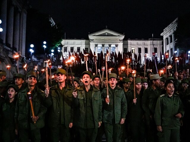 TOPSHOT - Cuban soldiers take part in the Torchlight March on the 173rd anniversary of Nat