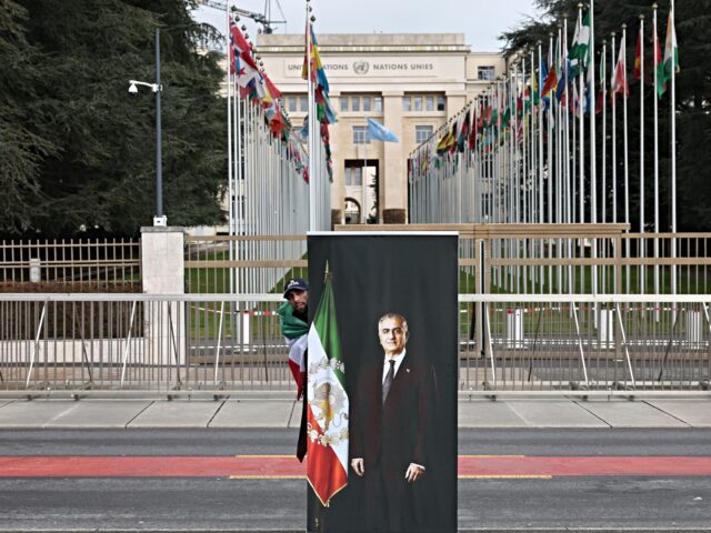 GENEVA, SWITZERLAND - FEBRUARY 17: People gather with Iranian flags and posters in support