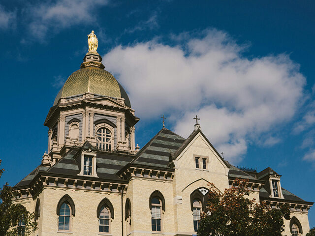 Statue of Mary and the Golden Dome on top of Notre Dame University Administration Building
