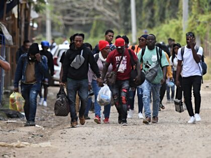 Cuban and Haitian migrants en route to the United States leave the Migrant Care Center aft