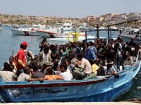 Would-be immigrants arrive on a boat in the port of Italy's southern island of Lampedusa l