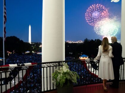 President Donald Trump and First Lady Melania Trump watch fireworks from the Truman Balcon