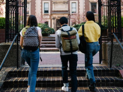 Back View of People Walking into a Campus