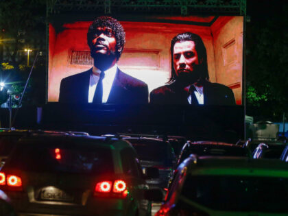 Cars at a drive-in movie of 'Pulp Fiction', showing Samuel L Jackson and John Tr