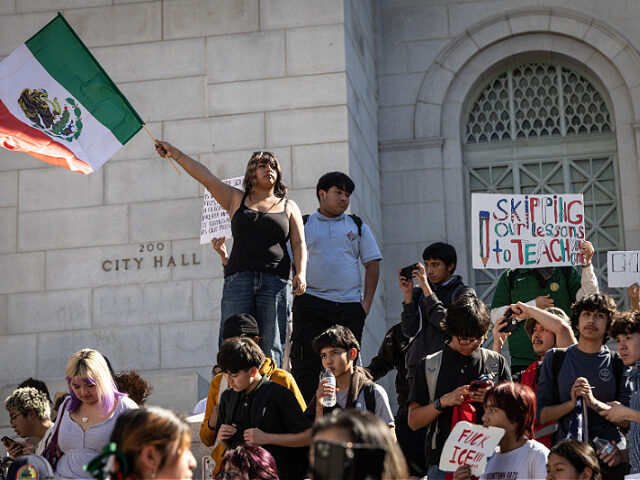 Los Angeles, CA - February 04: A girls waves a Mexican flag as fellow students from at lea