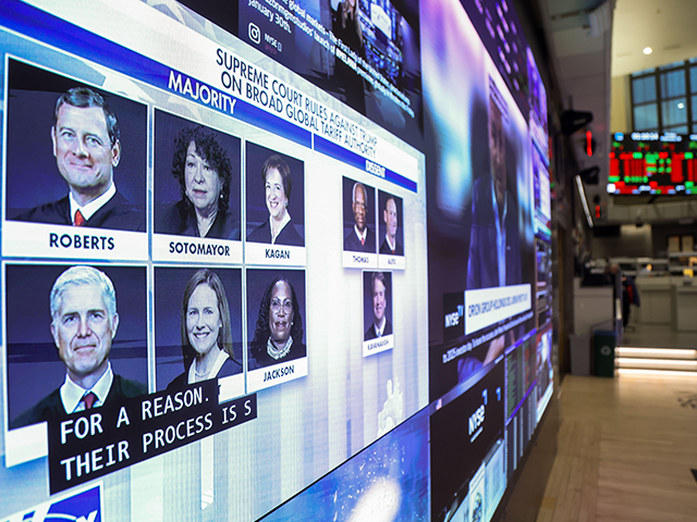 scotus-tariffs-nyse-getty Photos of the U.S. Supreme Court justices are displayed on a television screen on the floo