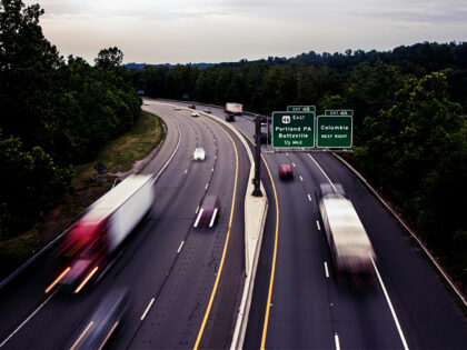 Fast Moving Cars on an Expressway / truck traffic