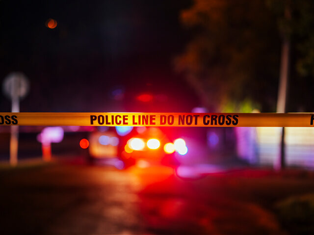Police tape reads, "Police Scene Do Not Cross," as the scene of a shooting, June 16, 2023