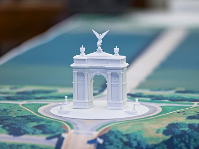A model of an arch on the Resolute Desk during a news conference in the Oval Office of the
