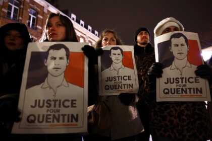 Demonstrators in Lille hold portraits in tribute to slain far-right activist Quentin Deran