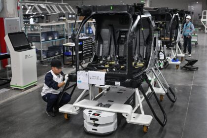 Employees work on an assembly line for electric flying cars, which will require critical m