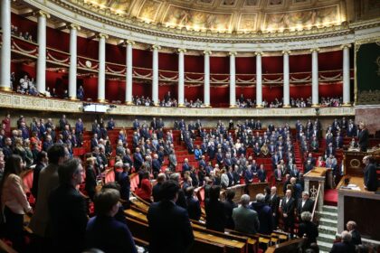 Members of the French parliament stand for a minute of silence in tribute to Quentin Deran