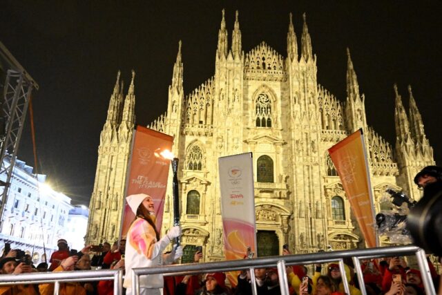 The Olympic flame reached the cathedral in Milan ahead of Friday's opening ceremony