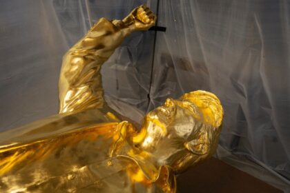 The statue depicts US President Donald Trump standing defiantly with his fist raised after