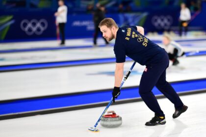 Sweden's Rasmus Wrana competes in curling at the 2026 Winter Olympic Games in Cortina