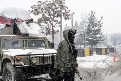 Taliban security personnel stand guard at a checkpoint in Kabul
