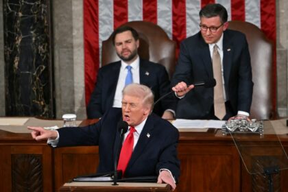 US President Donald Trump gestures toward Democratic members of Congress as he delivers th