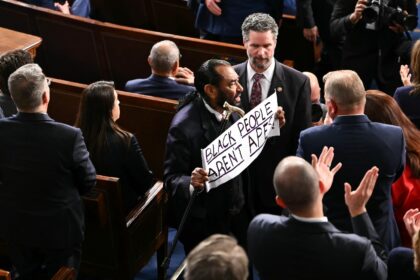 US Representative Al Green, a Democrat from Texas, holds a sign reading "Black people