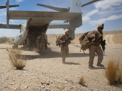 U.S. Marines assigned to 2nd Battalion, 7th Marine Regiment dismount an MV-22B Osprey assi