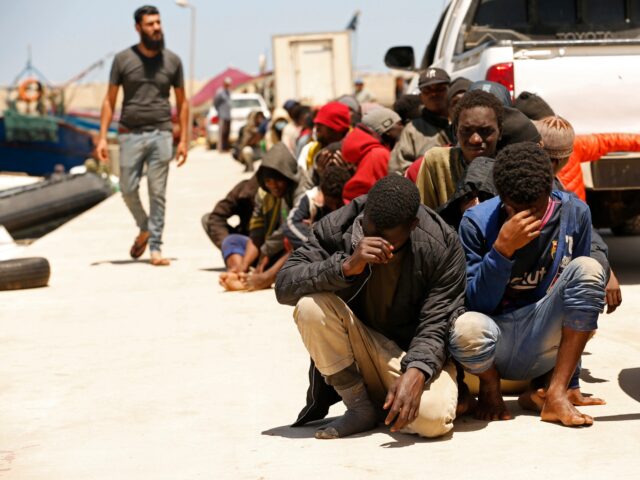 Migrants heading to Europe are detained after being intercepted in the Mediterranean Sea b