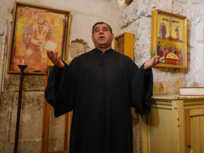 Father Fadi Bargeel prays at the Church of Saints Sergius and Bacchus in the town of Maalo