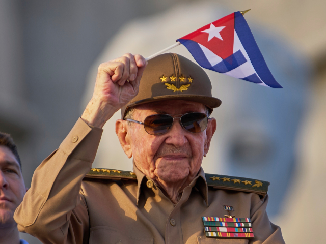 Raul Castro waves a Cuban national flag while attending the May Day parade at Revolution S