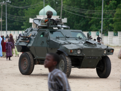 FILE - Nigerian soldiers ride on an armored personnel carrier during Eid al-Fitr celebrati