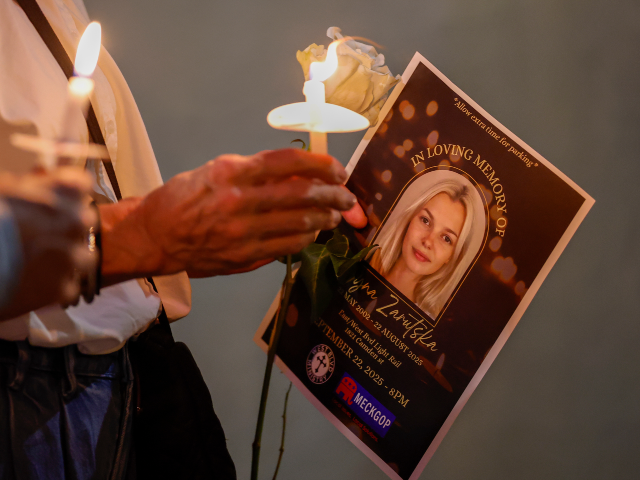 FILE - Community members hold candles as they gather for a vigil honoring the life of Iryn